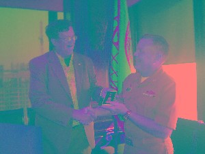 CHapter President Bob Whitkop (Capt, USN Ret) presents Cpat Slevin with a Divot tool for repairing the many greens he damages